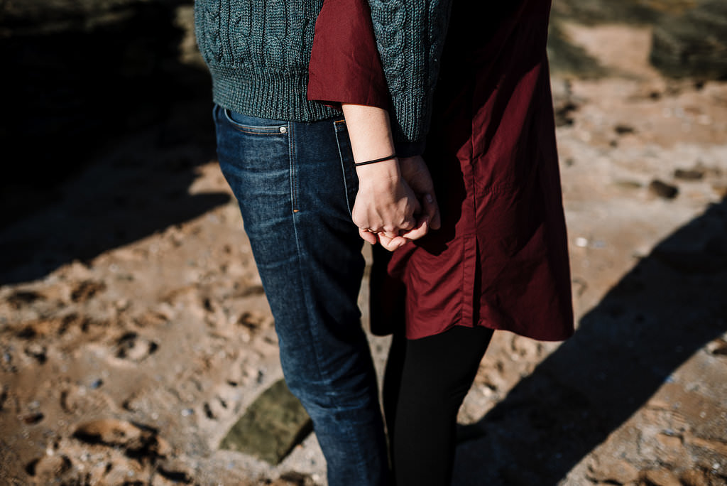 Detailed shot of arms and hands entwined. Modern engagement photography West Kirby