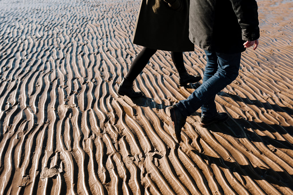 Detailed shot of the sand and feet