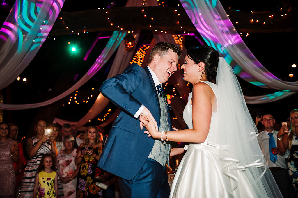 Colourful and fun photo of the bride and groom during their first dance at Rivington Hall Barn.