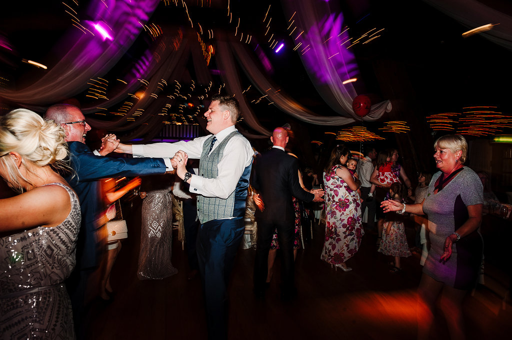 Colourful dance floor shot at Rivington Hall Barn. Bolton Wedding Photography
