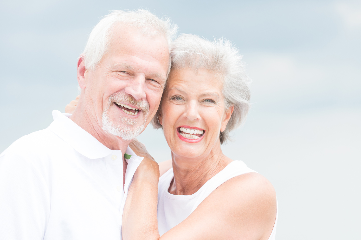 A smiling couple with hearing loss.