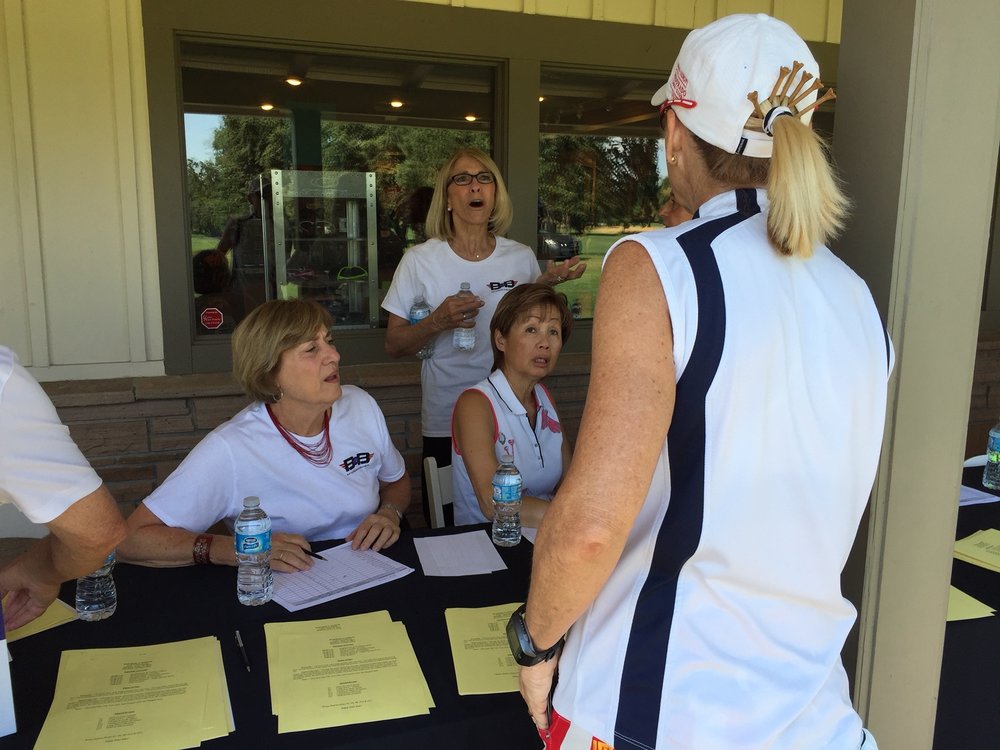  Checking in a full field of 148 golfers. 