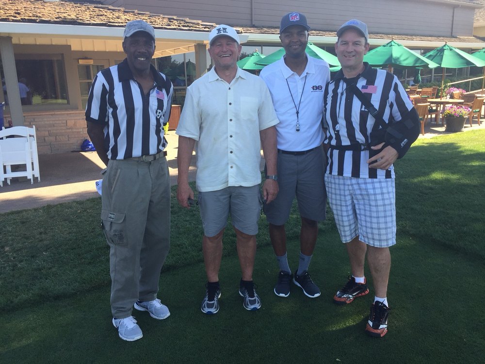  NFL referee Ed Hochuli (second from left) visits with Sacramento area officials. 