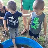 helping a friend balance while he tests out the sandy water
