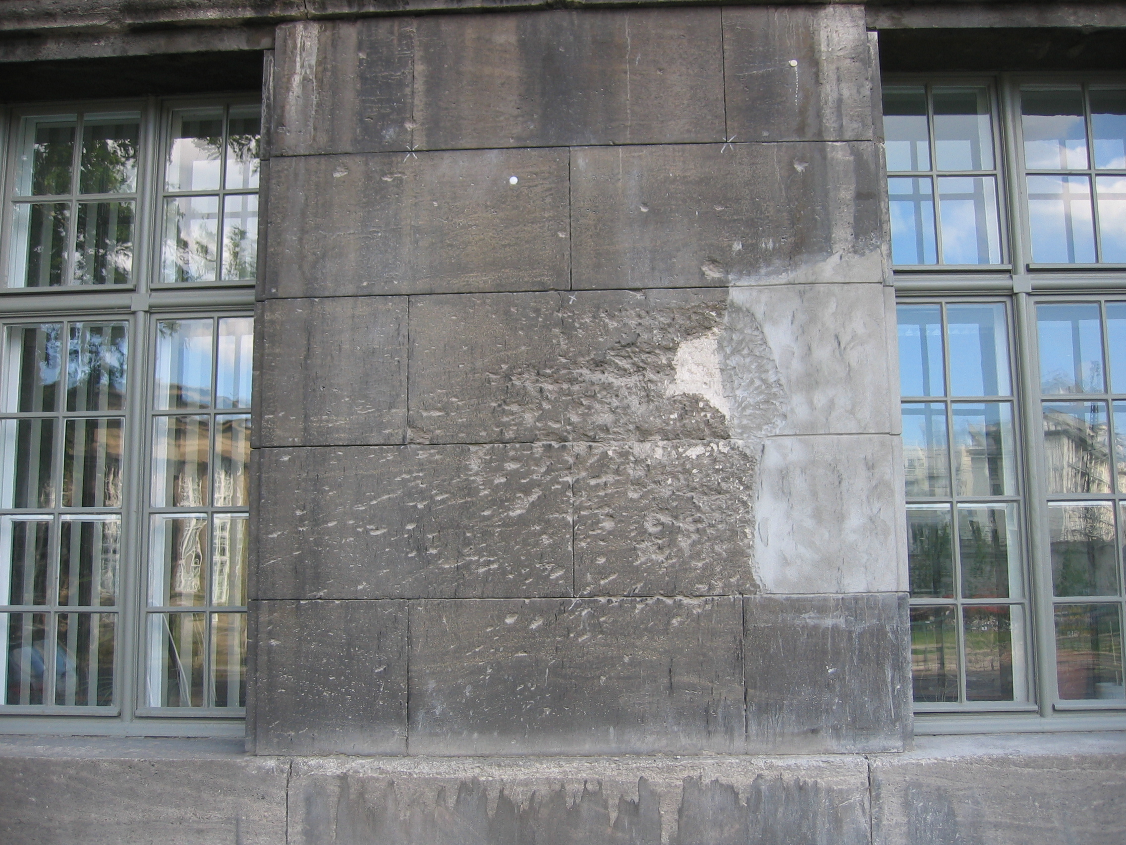 Photograph of the back of the Pergamon Museum Berlin, Germany with tank shell shrapnel spray impact from WW II