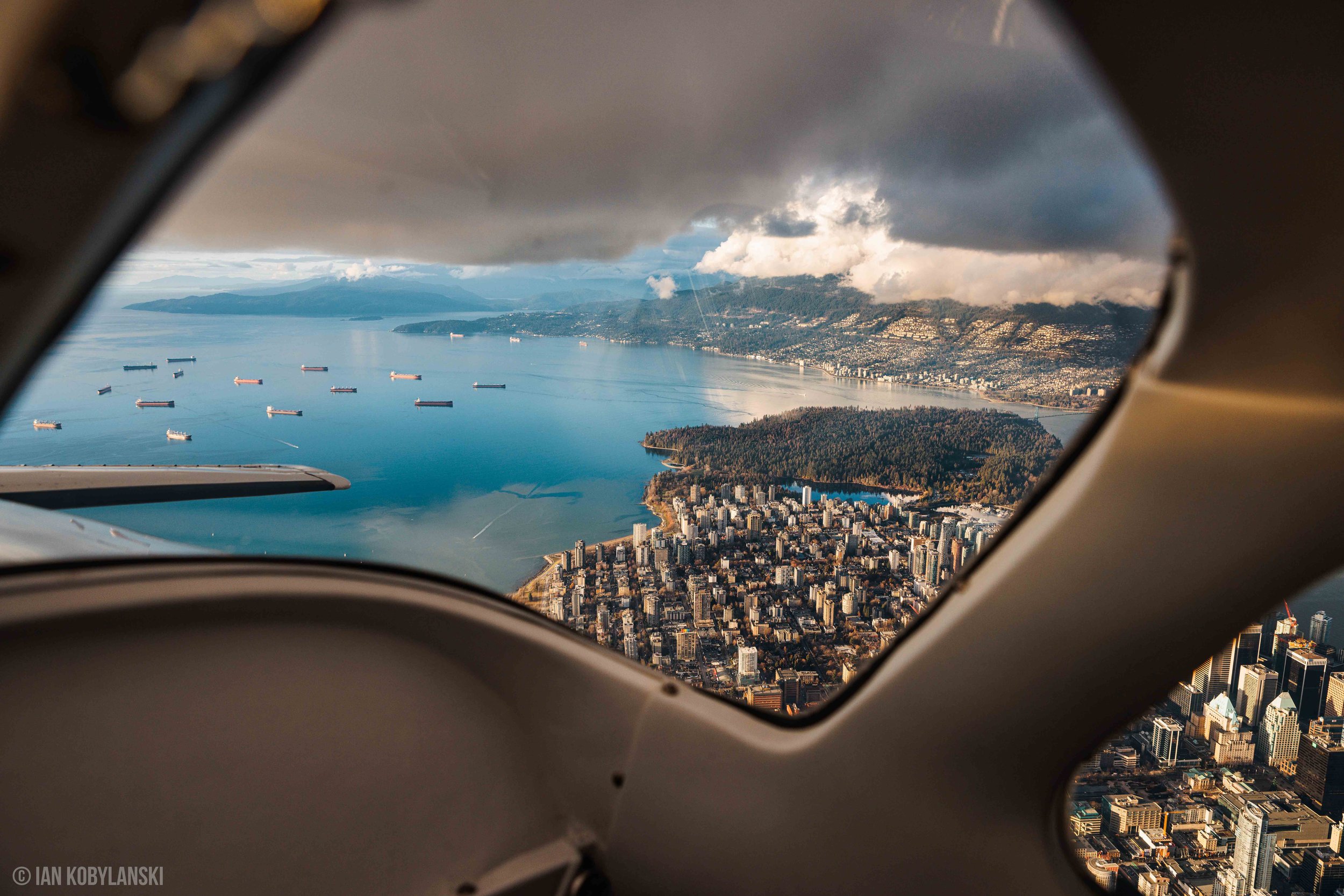  Stanley Park, English Bay, the West End, and West Vancouver across the water captured from the back window of our airplane. 