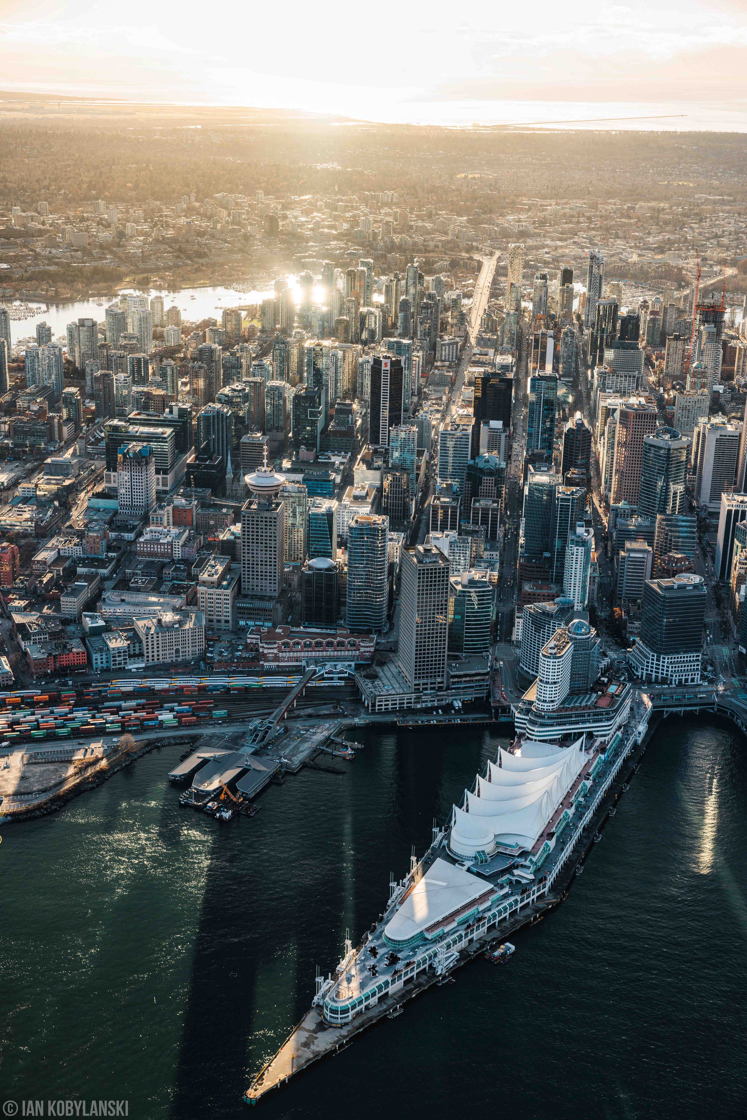  Vancouver’s Canada Place and the Convention Centre view looking South from Coal Harbour against the backlit sunset. 