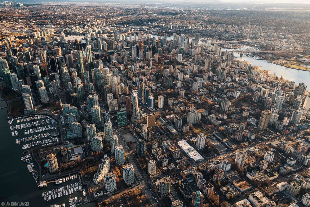  The whole expanse of Vancouver’s Coal Harbour and West End, backlit by sunset with all of downtown Vancouver behind it. 