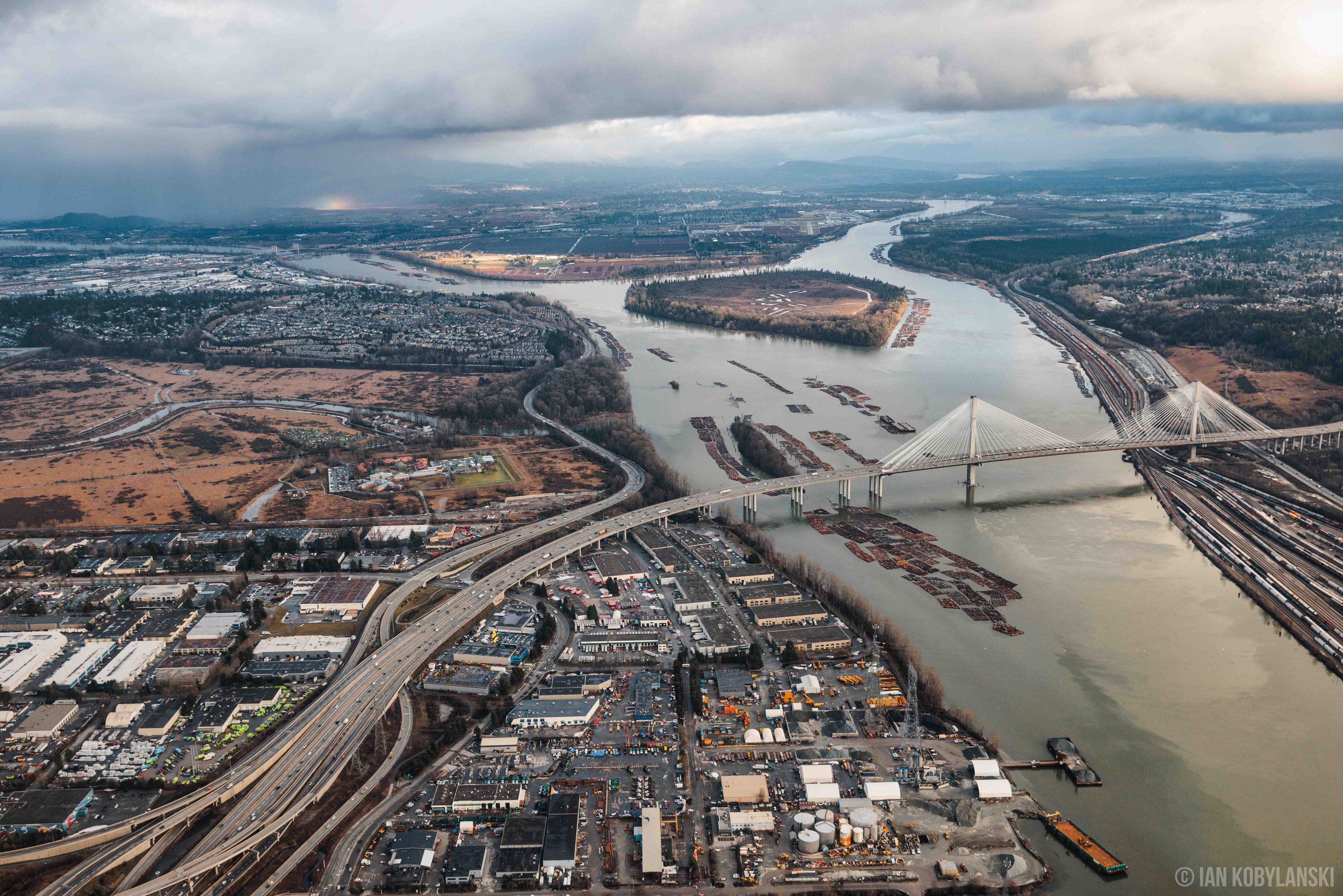  Port Mann bridge and the passing railcars beneath, leading into Surrey, B.C. 