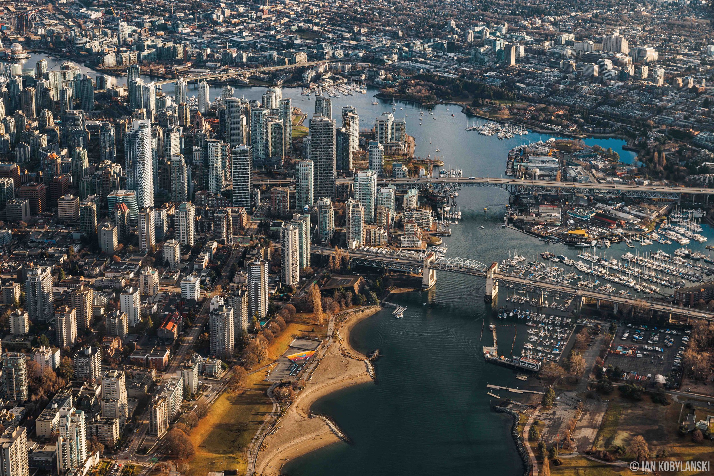   “Granville Island and False Creek”.  Situated under the Granville Bridge, this aerial photo from 2023 shows the unique juxtaposition of the Granville Island community amongst False Creek and the surrounding downtown.  Available as a fine art print 