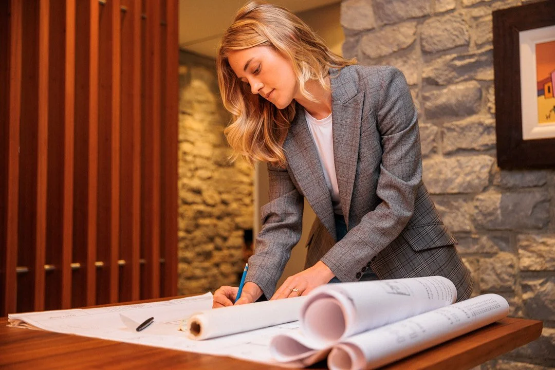 Personal branding photography in London of woman filling out architecture designs