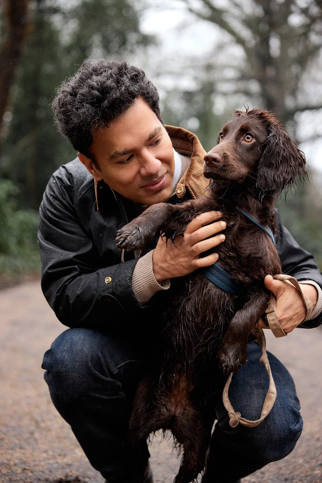 Dating photography portrait of man holding dog in forest