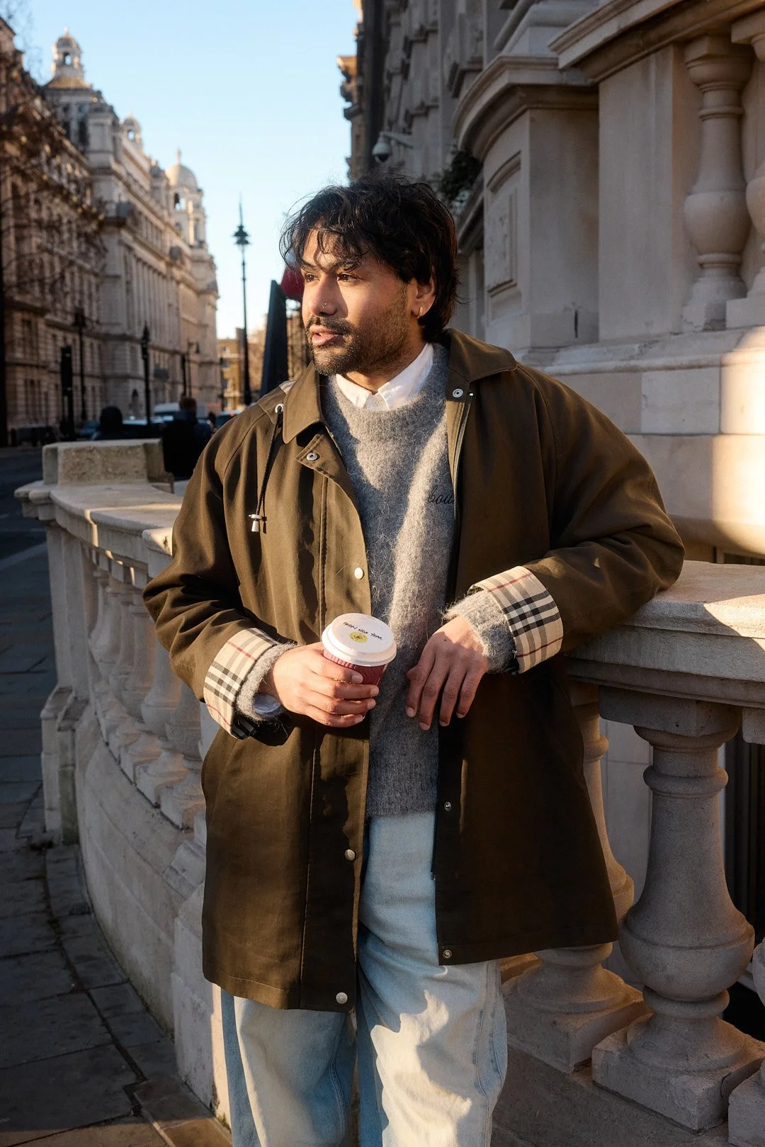Dating profile photography portrait in London of man looking off with coffee in hand