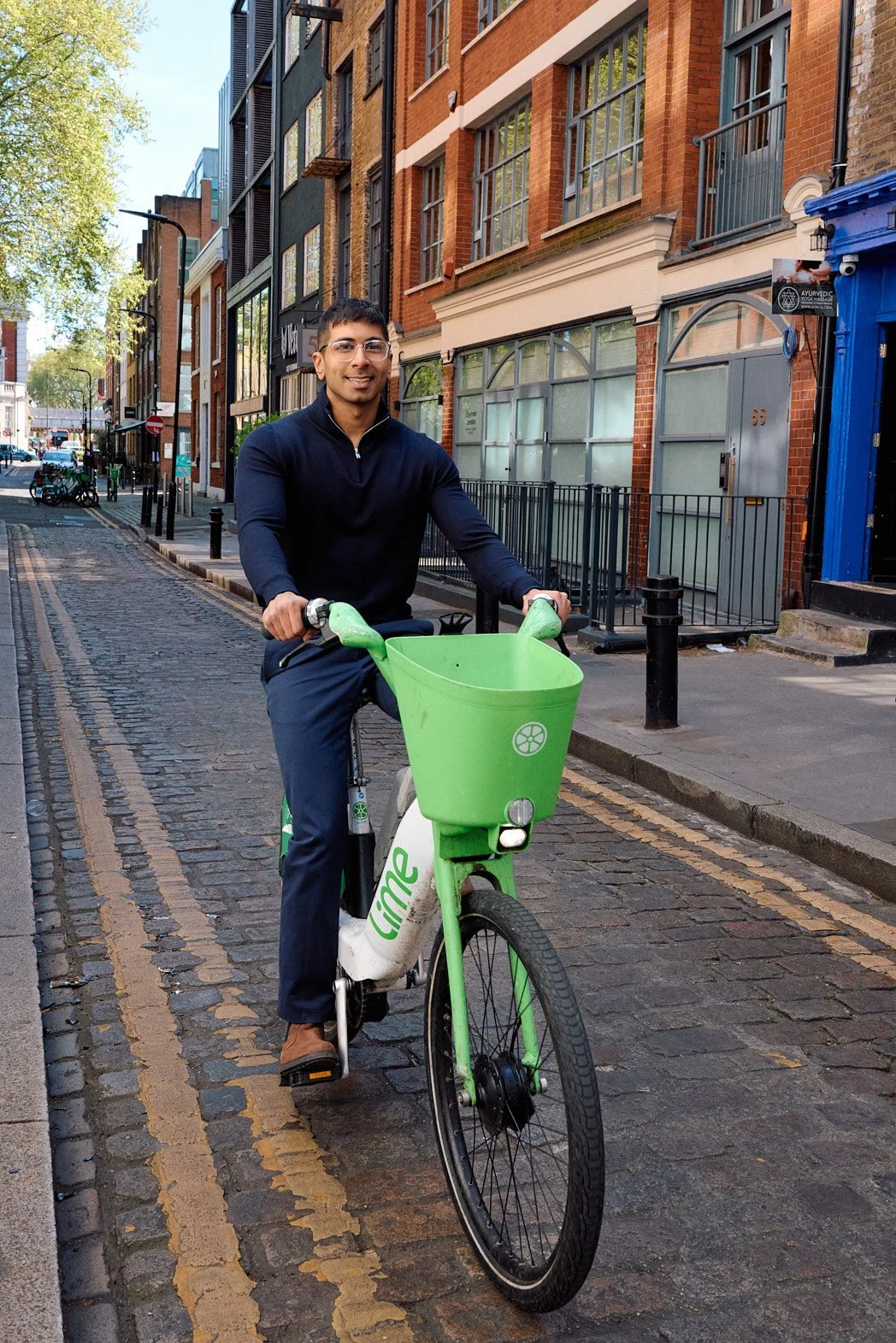 Dating photography of man riding a Lime bike in London smiling at camera