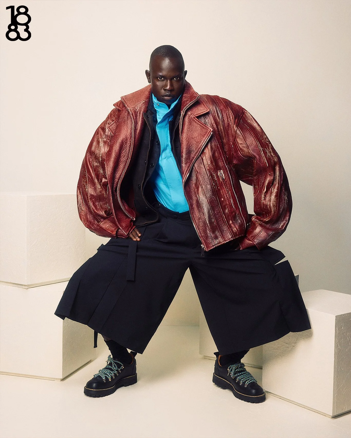 Fashion photography in London for 1883 Magazine of dark skin model in red leather jacket