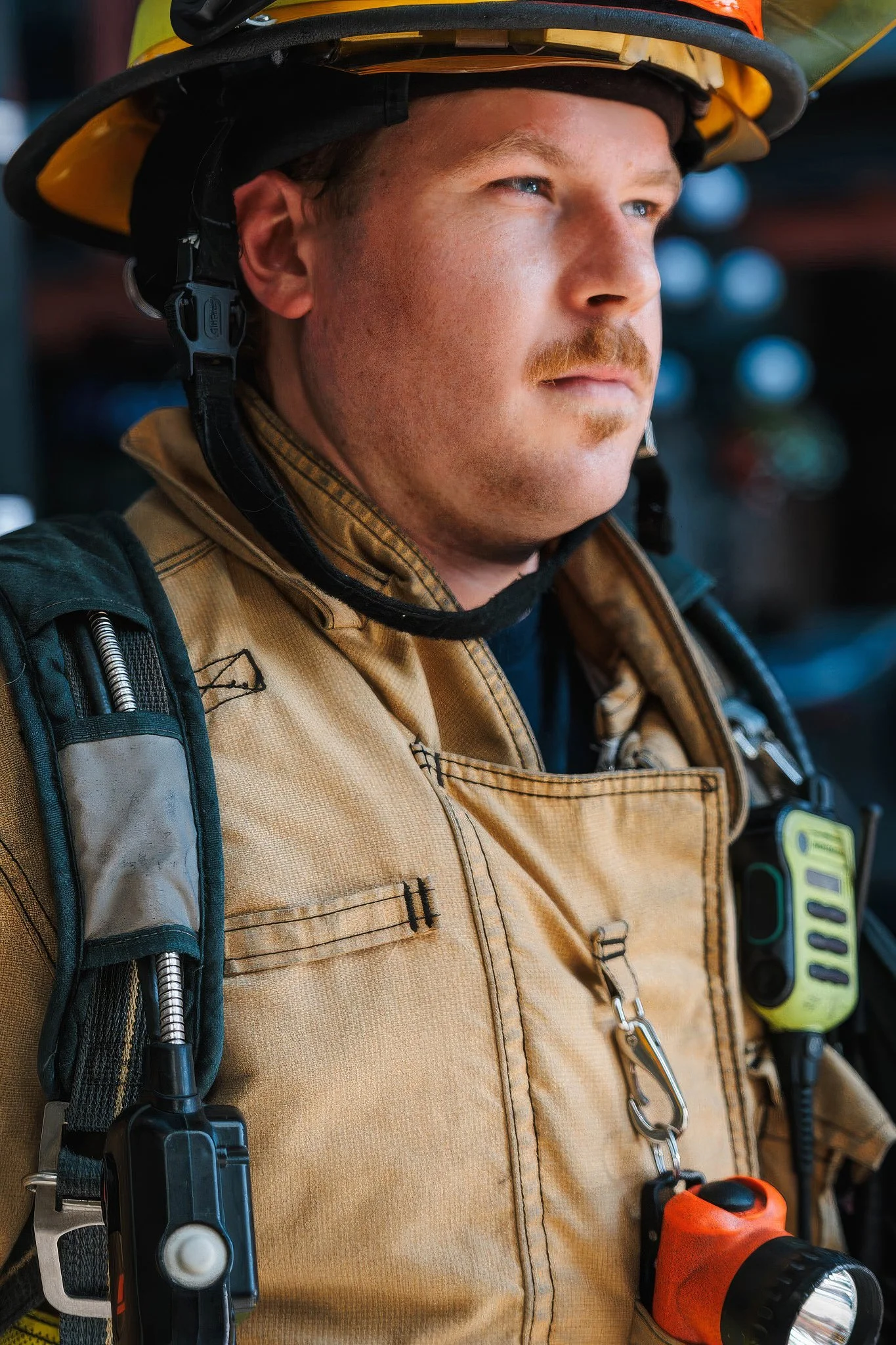 Advertising photography candid documentary portrait of firefighter with confident expression on call close up