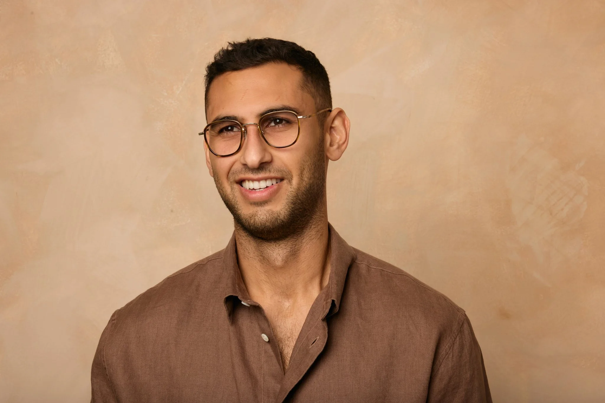 Headshot photographer in London takes relaxed portraits with warm colours in East London studio