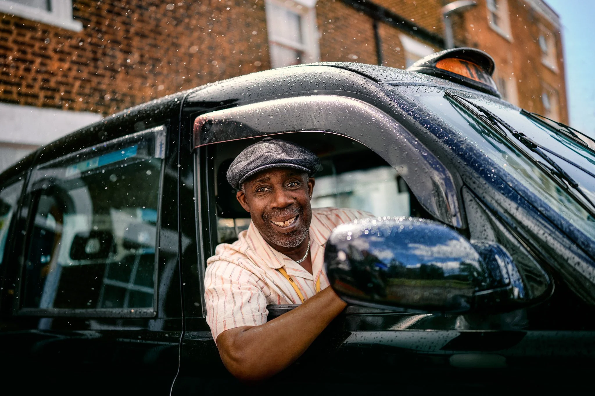 Advertising photography and street photography in London for IBM billboard OOH ad campaign for Wimbledon tennis tournament with lifestyle street photography of cab driver smiling at camera looking out taxi window