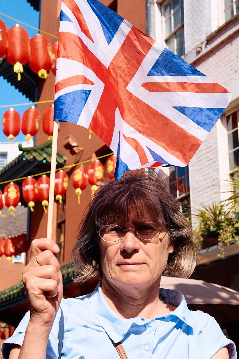 Woman with a Union Jack flag in Chinatown, photographed by London street photographer Ian Koby