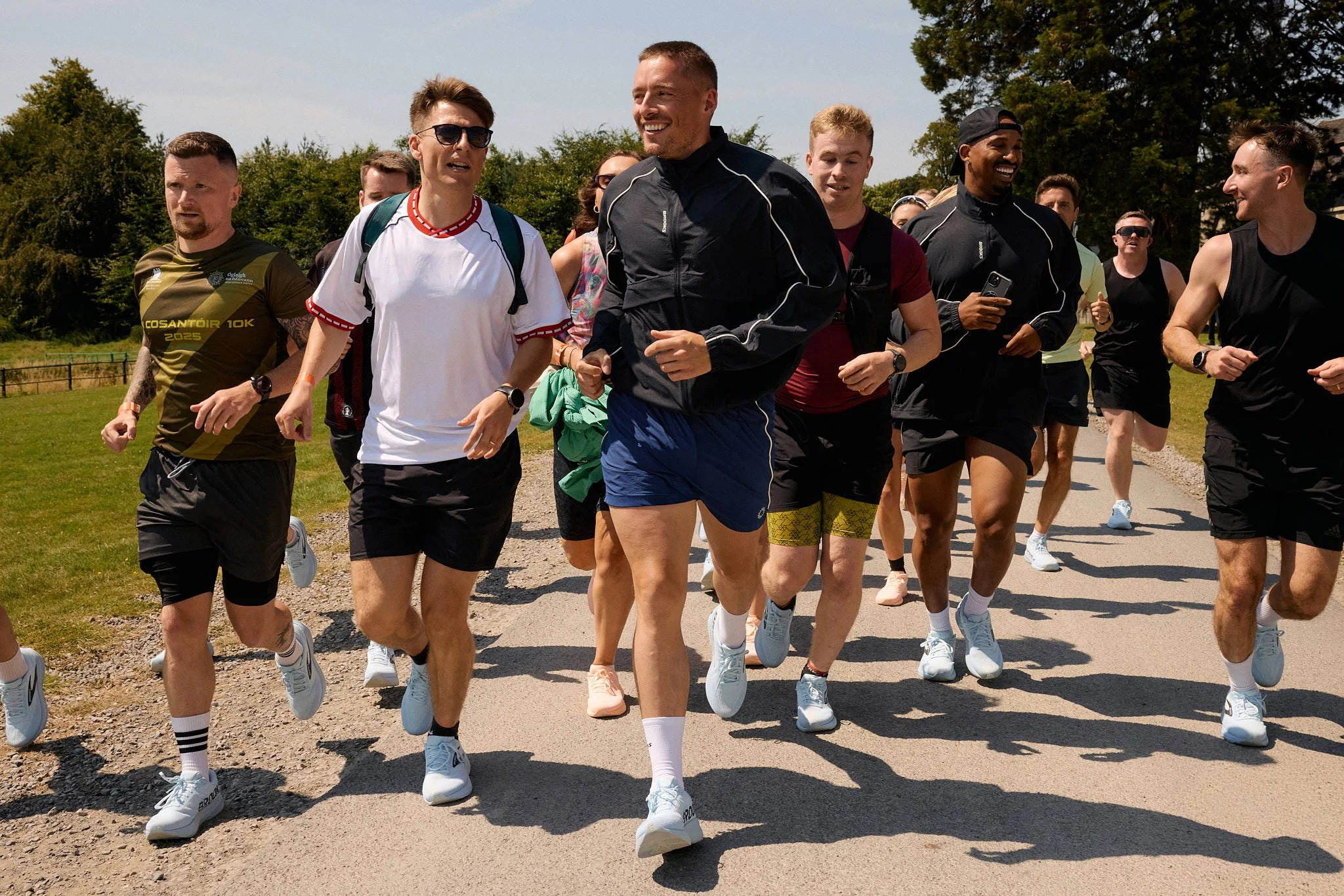 Dermot Kennedy smiling as he leads DK5K runners along a sunny estate drive at Russborough House, County Wicklow