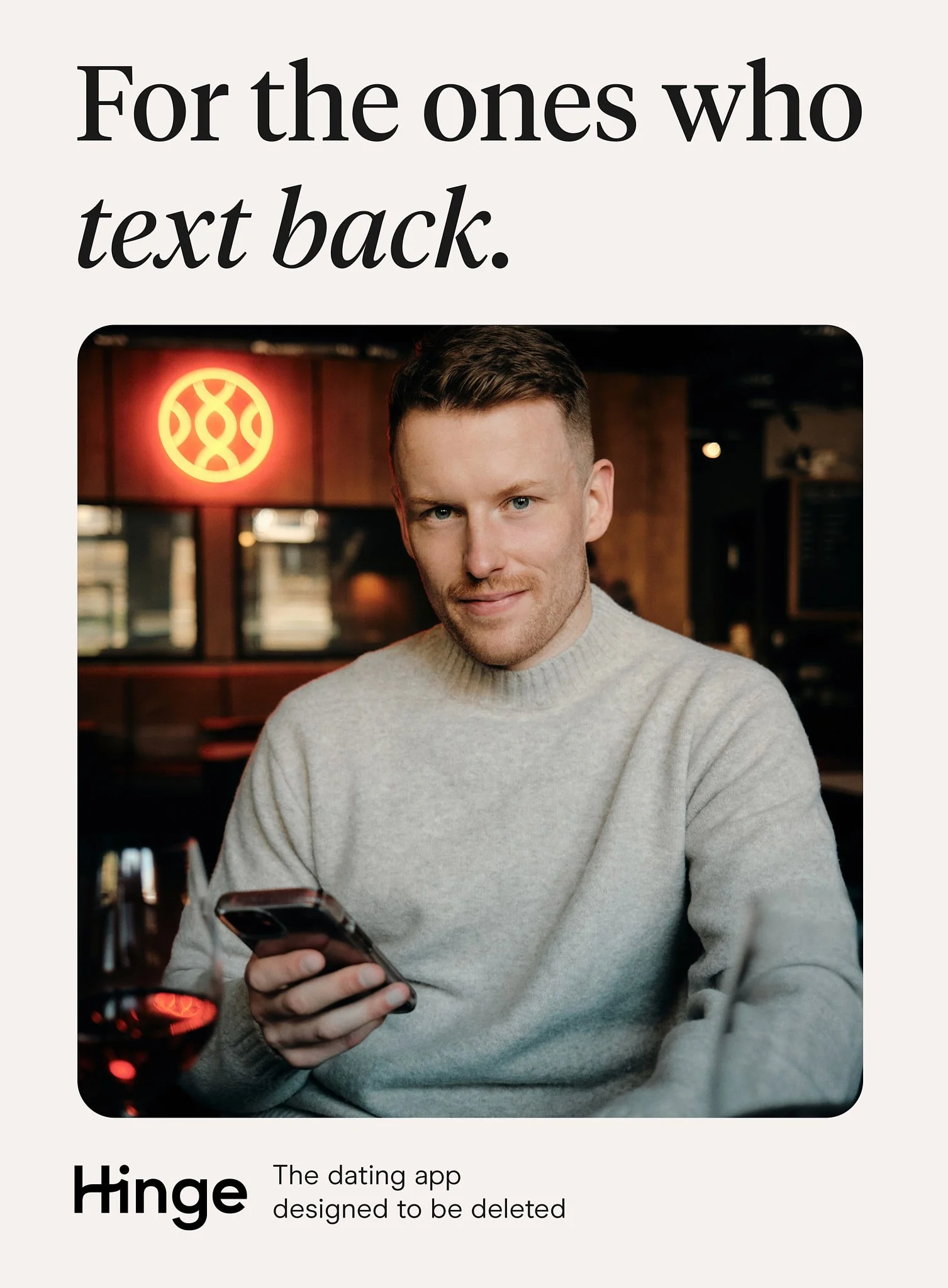 Advertising photography in London for Hinge of man looking at camera dating photo portrait with phone in hand