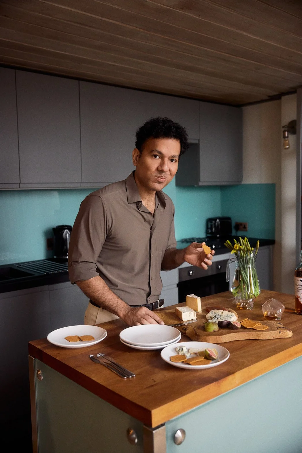 Dating photography portrait of man hosting with charceuterie board, pouring drinks