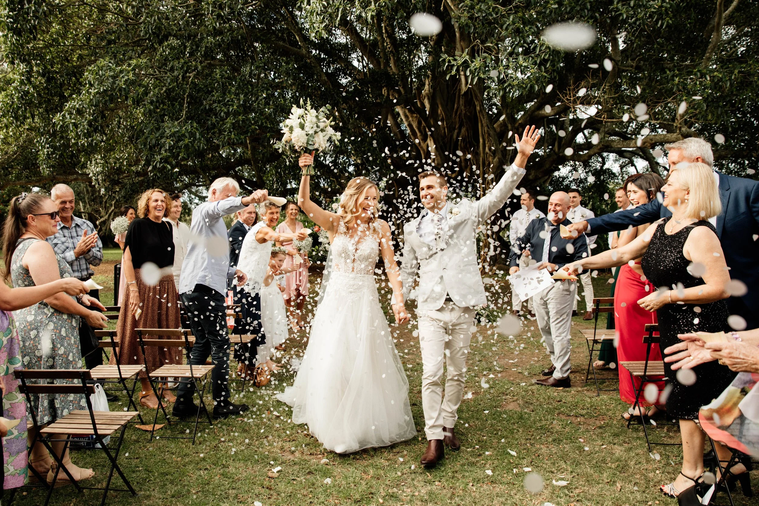 photo of couple walking down the aisle with confetti at Tocal Homestead
