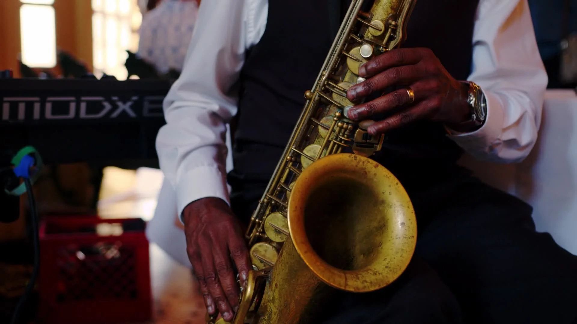 Person holding a saxophone playing jazz music