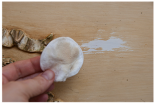 Latex paint being reemoved by acetone soaked pad. Photo source: http://salvagedinspirations.com