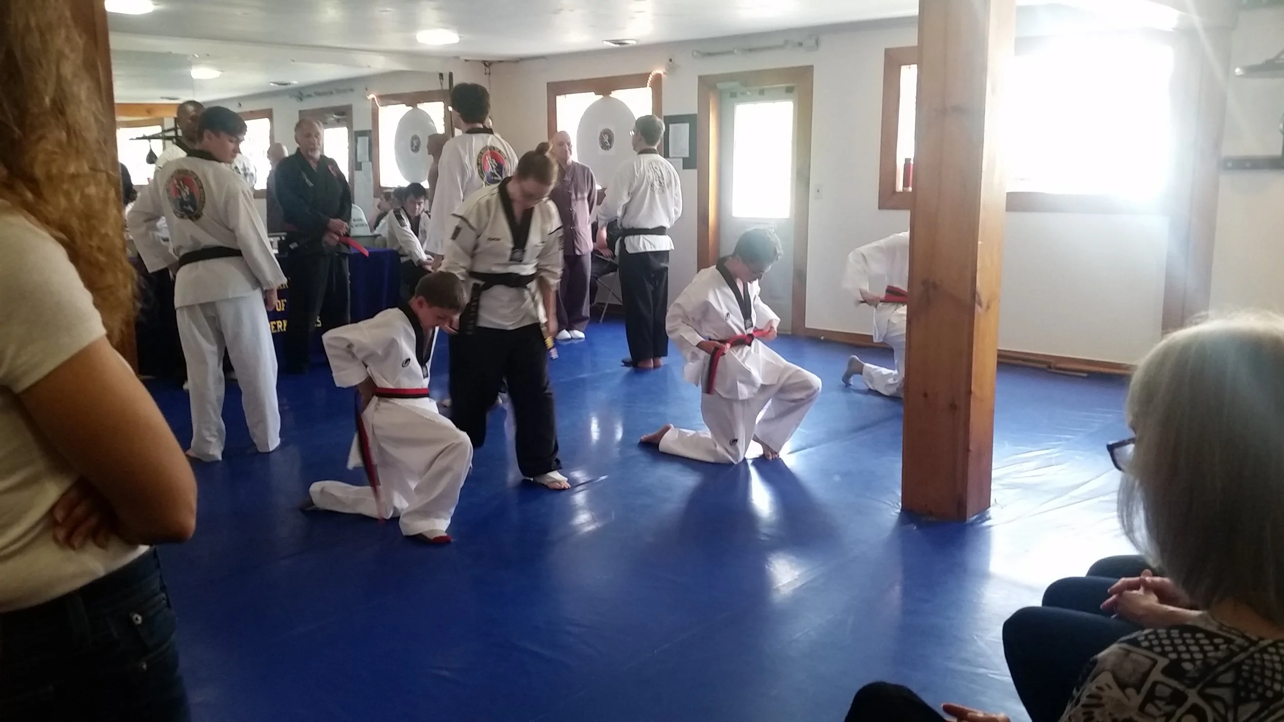 First Dan Candidates kneel to tie their belts at the beginning of the test.
