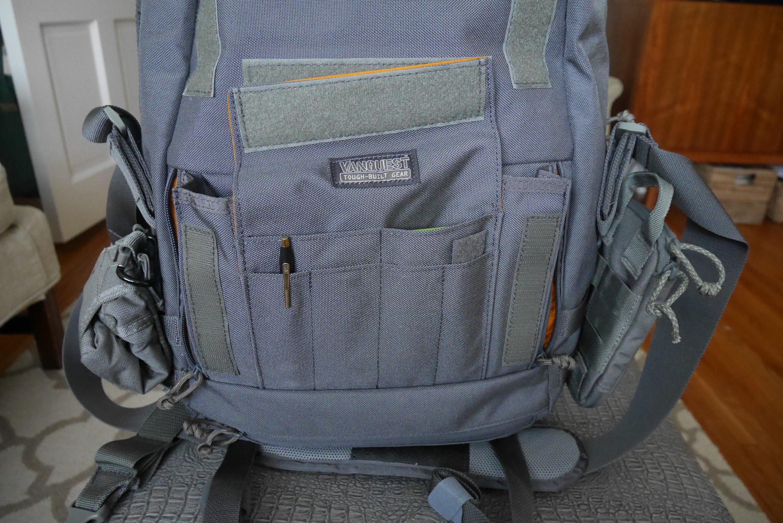 The front "admin" set of pockets under the flap. Behind these is a small, tight pocket and then two larger pockets.