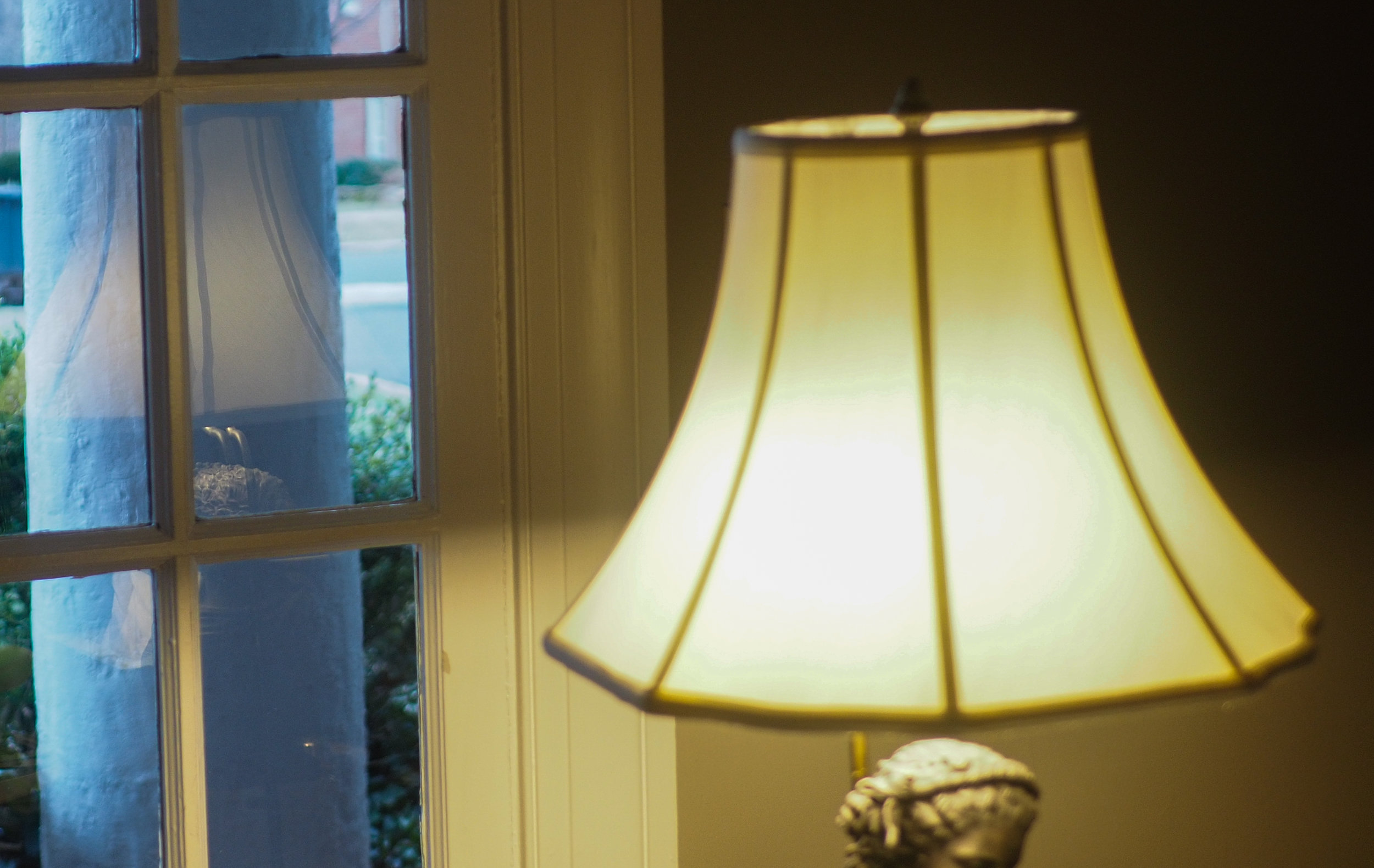 Simple reflection of table lamp in door windows.