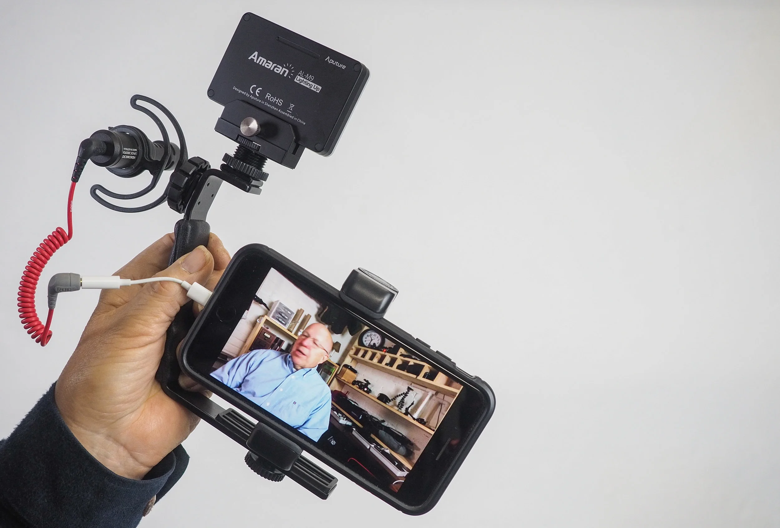 A mobile video "kit" complete with smartphone, microphone, and LED light.