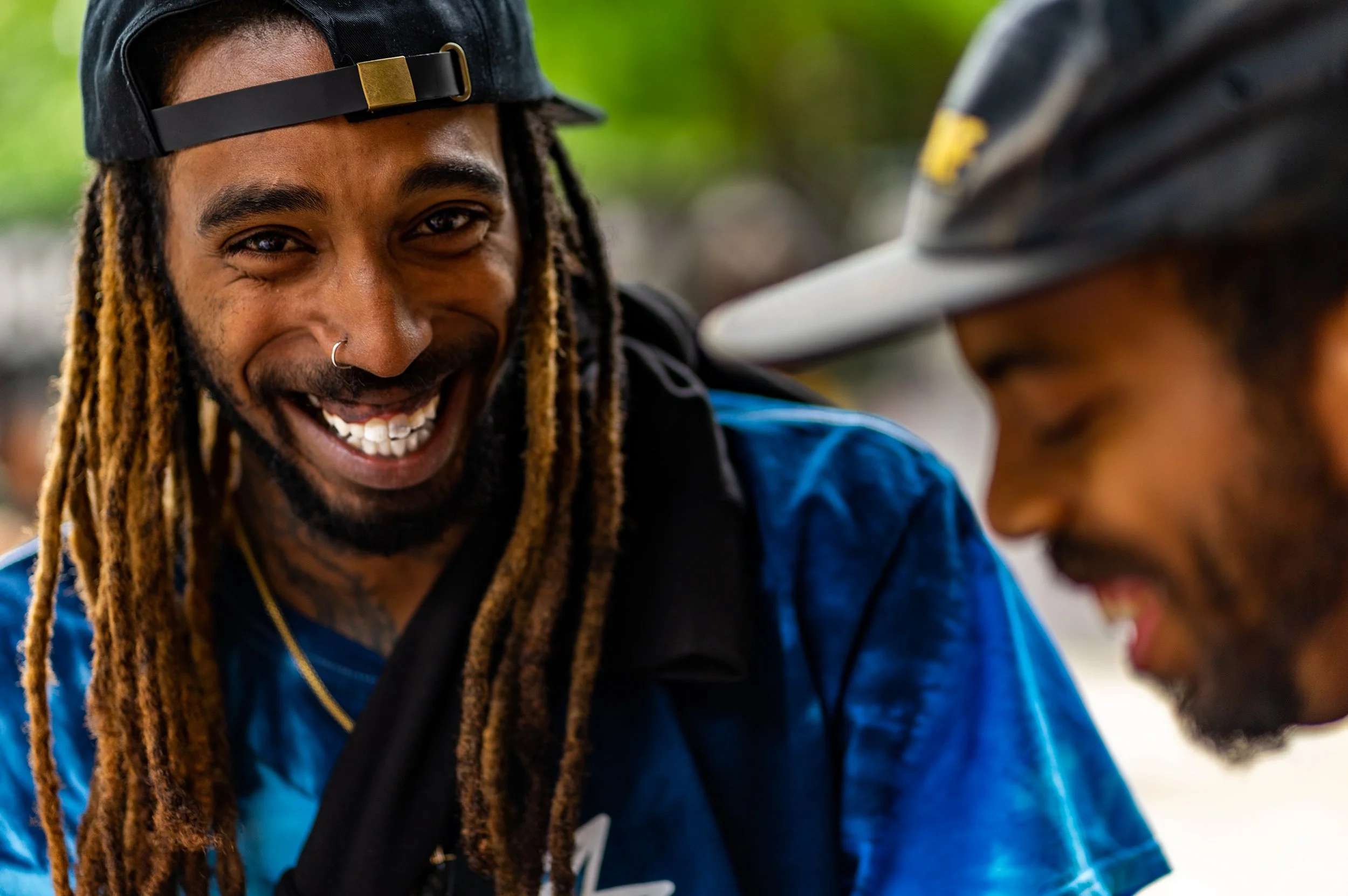 Close up portrait of skateboarder with locs smiling. LES Skate Park. Natural lighting. Shot on Sony A7II