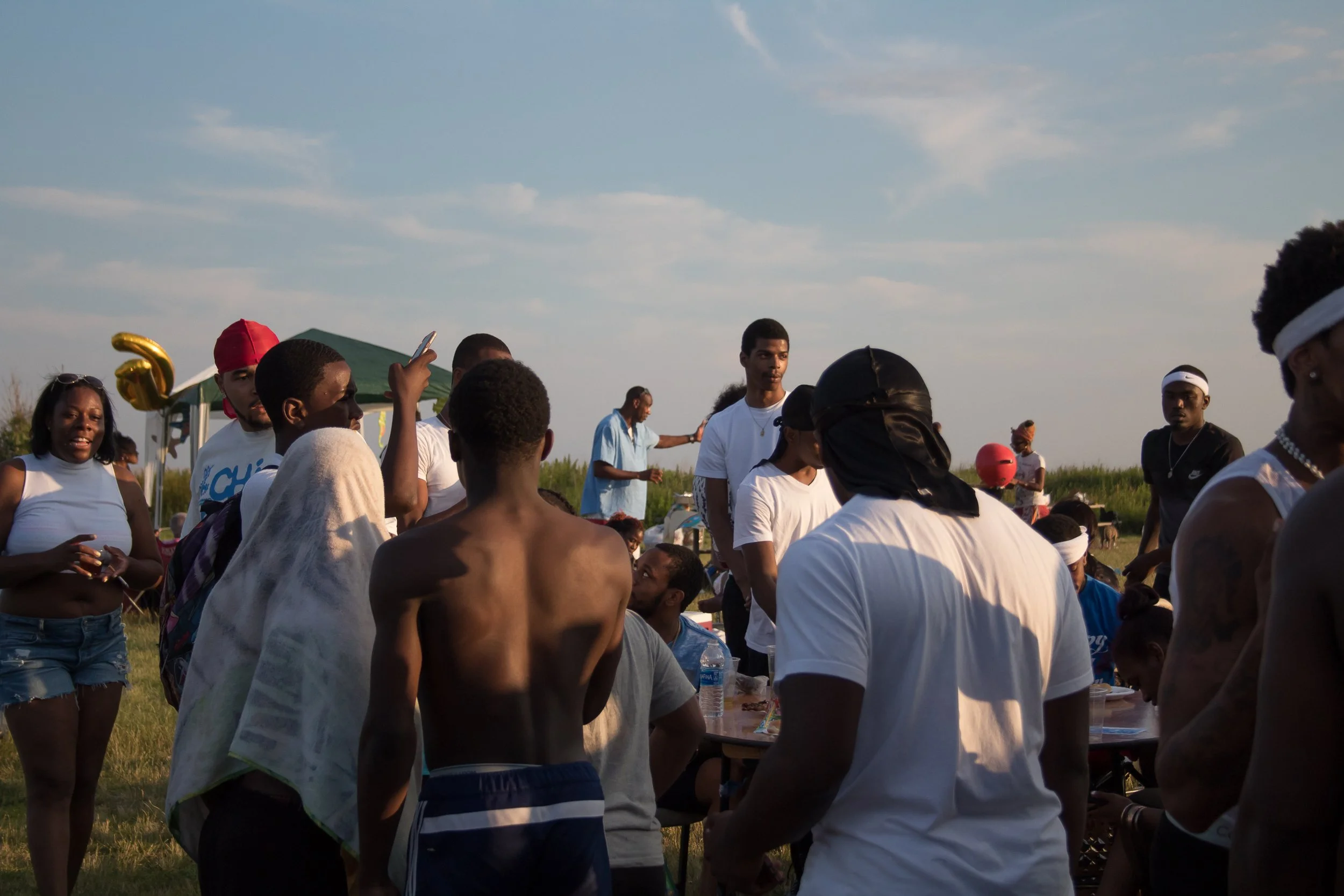 Photo of a summer time cookout. Jacob Riis Beach. Natural Lighting. Shot with Sony A7II. New York