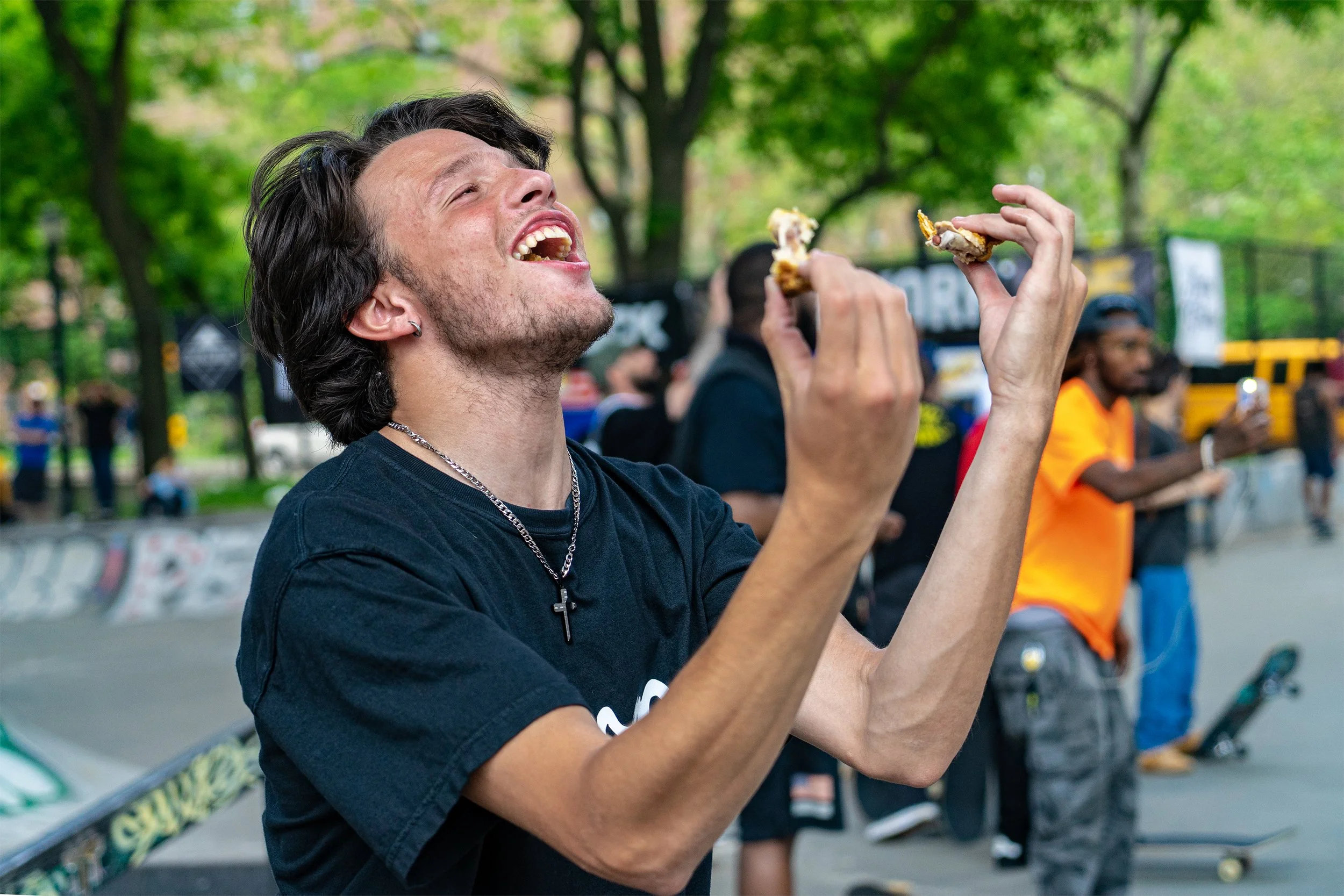 Portrait of young skater lamenting his dropped food. LES Skatepark. Natural lighting. Shot on Sony A7II