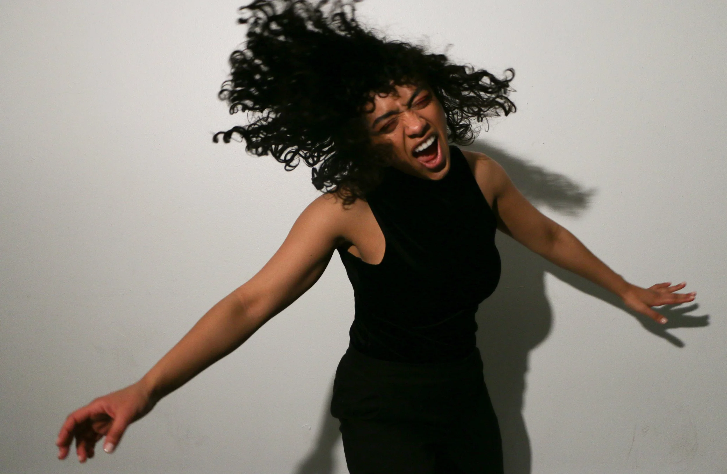 Action shot of a latinx woman whipping her hair back and forth. Parsons School of Design. Studio lighting. Shot on Sony A7II