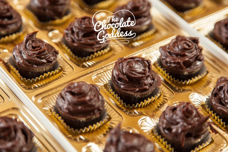 Bailey’s Irish Cream Truffle Shots
A New St. Patrick’s Day Dessert Better than a Pot of Gold!
There is something about St. Patrick’s Day that makes everyone happy. Maybe it is the time of year- spring is just around the corner, the days are a little longer and the sun is a little higher in the sky. Perhaps it is a fact that it is a day for celebration that has no responsibility for gift giving or tremendous dinner preparation. You can have a party with corn beef, cabbage and potatoes all made in one pot, not to mention this holiday is one where people give themselves permission to imbibe just a wee bit more than usual.
Here is the perfect dessert to top off your meal - The Chocolate Goddess calls them Bailey’s Irish Cream Truffle Shots. They are chocolate cordial cups but they are filled with Bailey’s Irish Cream ganache, making them in fact the most delicious Irish Cream Truffles!
Purchase 3 boxes of chocolate cordial cups (12 per box) at your local gourmet or chocolate store or order them online. Instead of filling them with liquors, the goddess has a new and improved idea. Here is the recipe:
Bailey’s Irish Cream Truffle Shots 36 Chocolate Cordial Cups 24 ounces of Ghiradelli® chocolate chopped very fine (I use the food processor). 2/3 cup of Heavy Cream 1/3 cup of Bailey’s Irish Cream ¼ teaspoon of Irish Cream oil (made for flavoring chocolate and very powerful). If you do not have this, 2 teaspoons of good quality vanilla will do.
Directions In a heavy saucepan, bring the cream to just boiling, stirring frequently so no skin forms on the cream. Pour the hot cream over chopped in a medium bowl and mix until dissolved. Add Bailey’s Irish cream and oil or extract.
Let the chocolate ganache sit just until it just begins to take form and then place about 2 teaspoons in each chocolate cordial cup, mounding it a bit. I swirled the top with a chopstick to give it a piped look. Elegant and delicious, I served them at a party last weekend and there wasn’t one left.
Accompany them with Irish coffee for a real treat. You could plate 3 for each person with a dollop of whipped cream on the side. Think kindly, if you are not having or going to a party, make them for a friend to put a smile in their Irish eyes - BE Goddess!