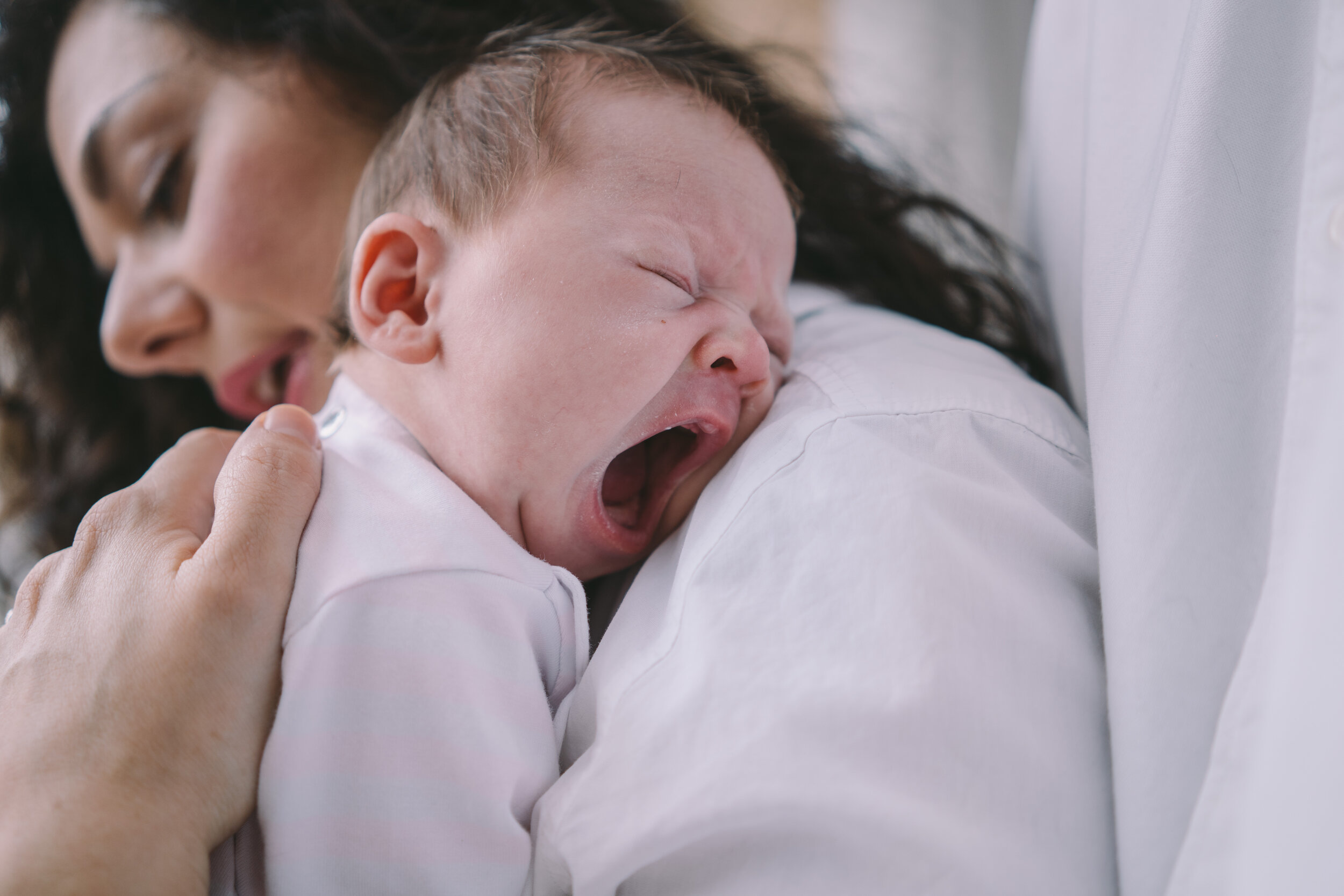 newborn-yawning-on-moms-shoulder.jpg