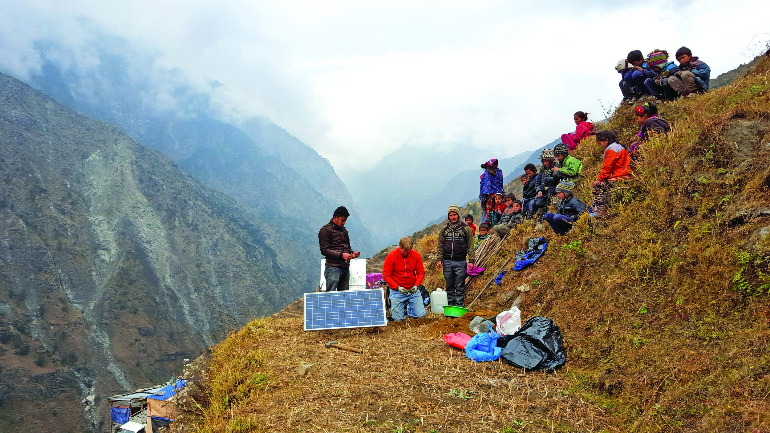 Navin Thapa, left, UTEP Department of Geological Sciences Research Associate Galen Kaip, and Nepalese driver Bijaya Khadka work with seismic sensors as local villagers watch. Photo courtesy of Marianne Karplus