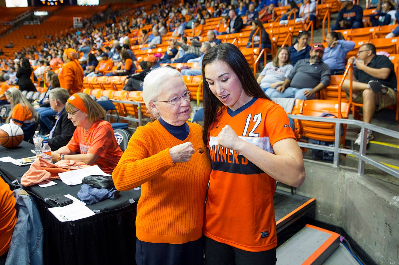 During a break at a UTEP basketball game in February 2018, Han chatted with President Diana Natalicio and showed her the proper way to form a fist to throw a punch. Photo by Ivan Pierre Aguirre