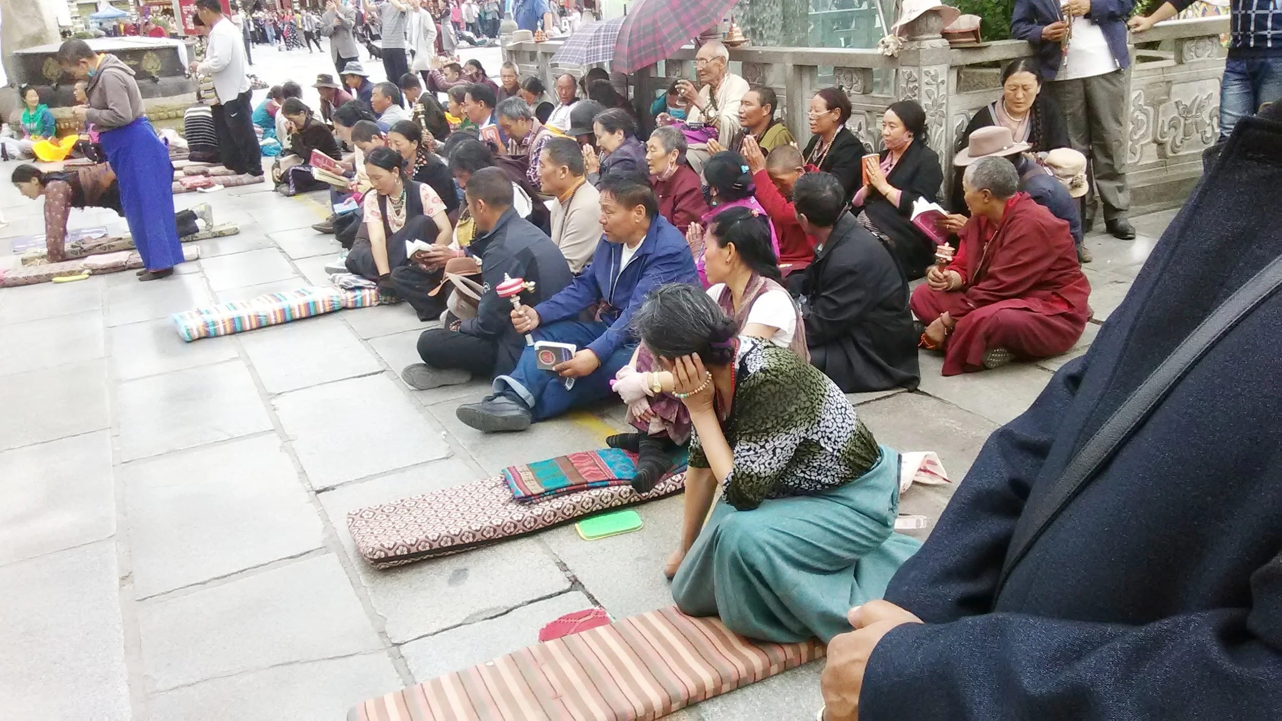 Tibetan pilgrims praying outside the Jokhang. Photo Dechen Steele.
