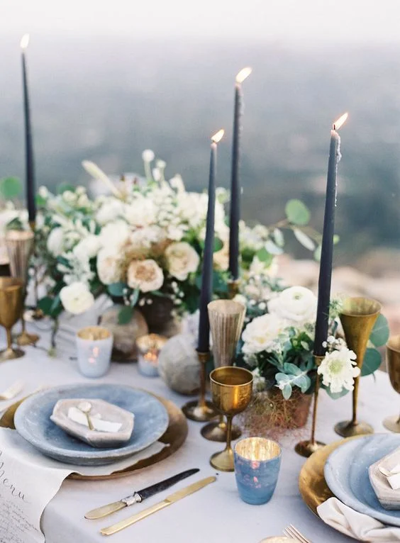04-a-moody-spring-table-setting-with-slate-blue-candles-brass-glasses-and-goblets-stone-inspired-plates-and-marbeleized-candle-holders.jpg