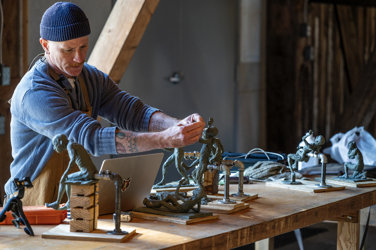 Artist working on clay figure