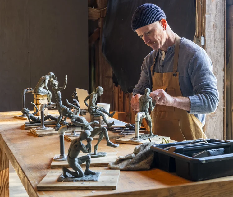 Artist working on clay figure