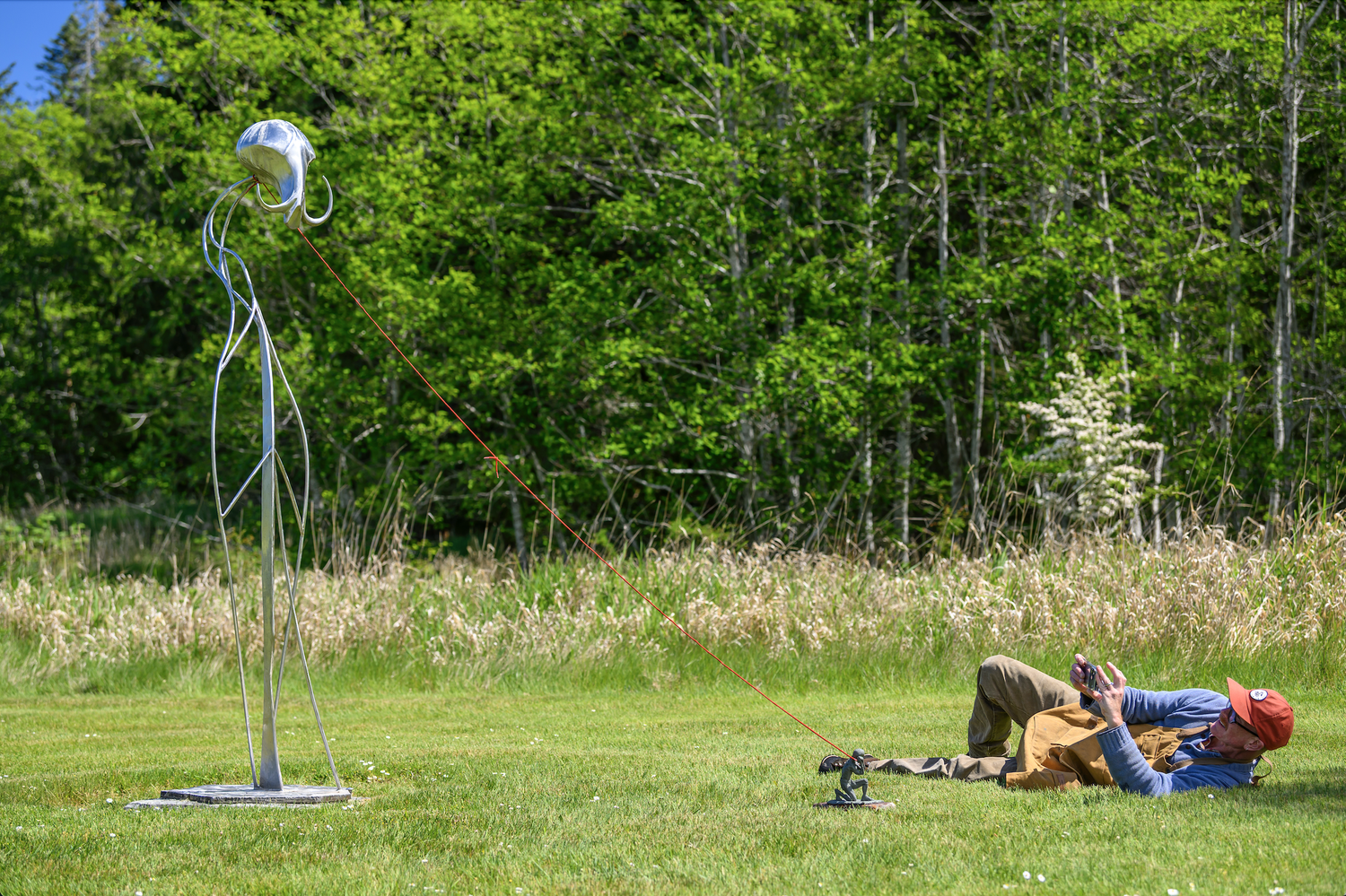 Clay figure and steel sculpture in the Jeffrey Rubinoff Sculpture Park