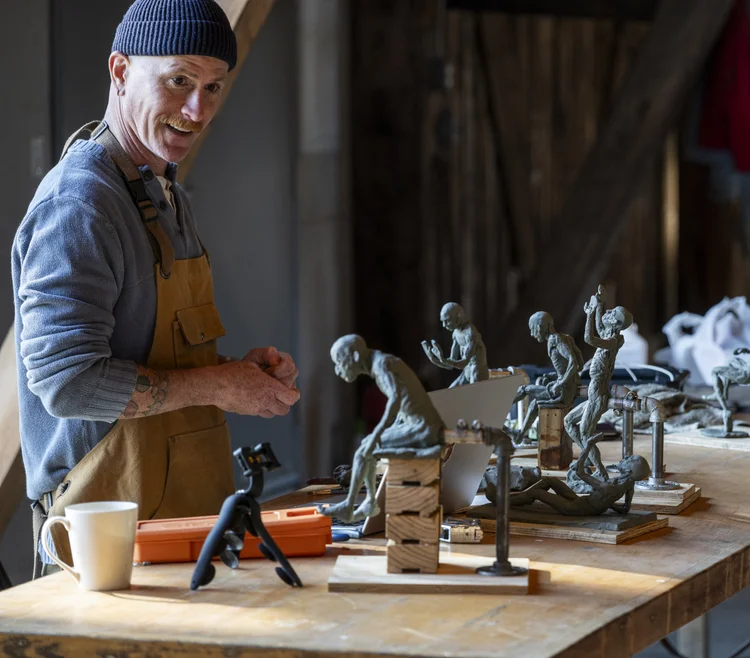 Artist working on clay figure