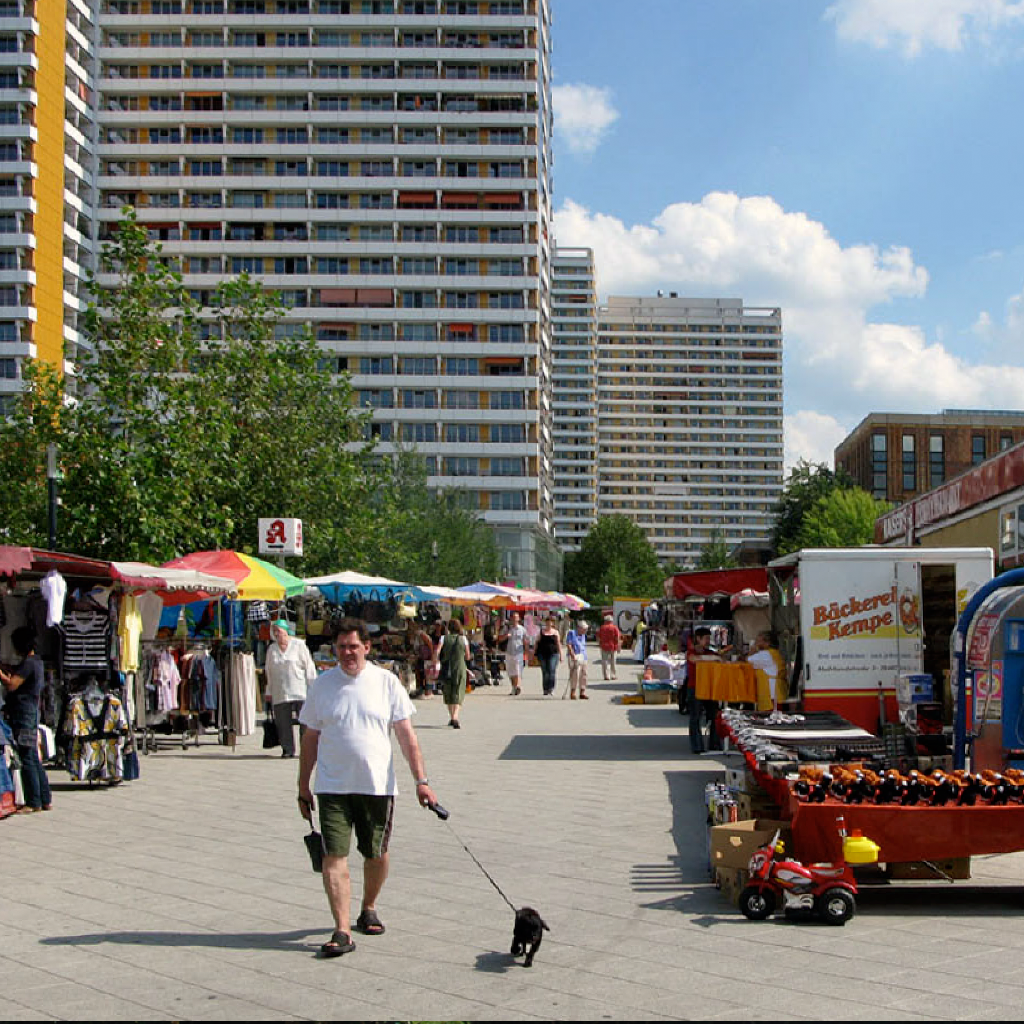   The scale in-between apartment towers feels different when they are activated by weekly markets.   Berlin, Germany 