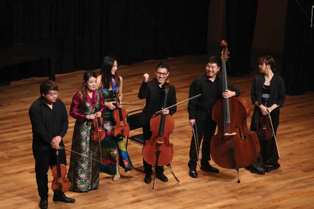 A chamber group takes in the audience’s response after a triumphant performance of a Silk Road–style arrangement during a Tomorrow Concert. Photo by Liang Yan