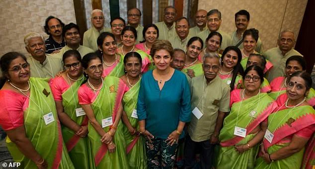 Neeta Helms, president and founder of Classical Movements, poses with the Madras Youth Choir from Chennai, India, ahead of the Serenade! choral festival in Washington